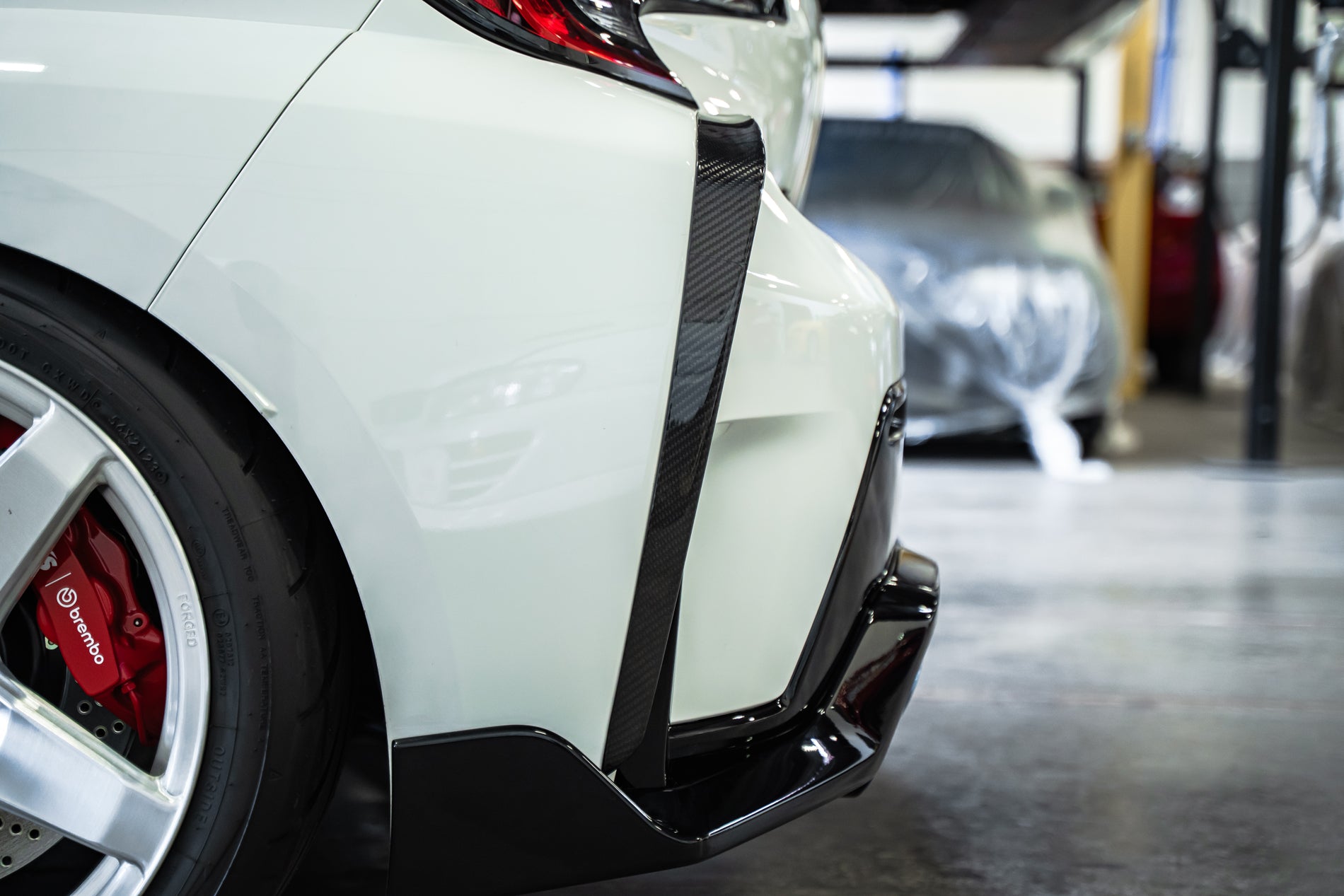 TOM'S Racing - Carbon Fiber Rear Bumper Garnish - Toyota GR Corolla [2023+]