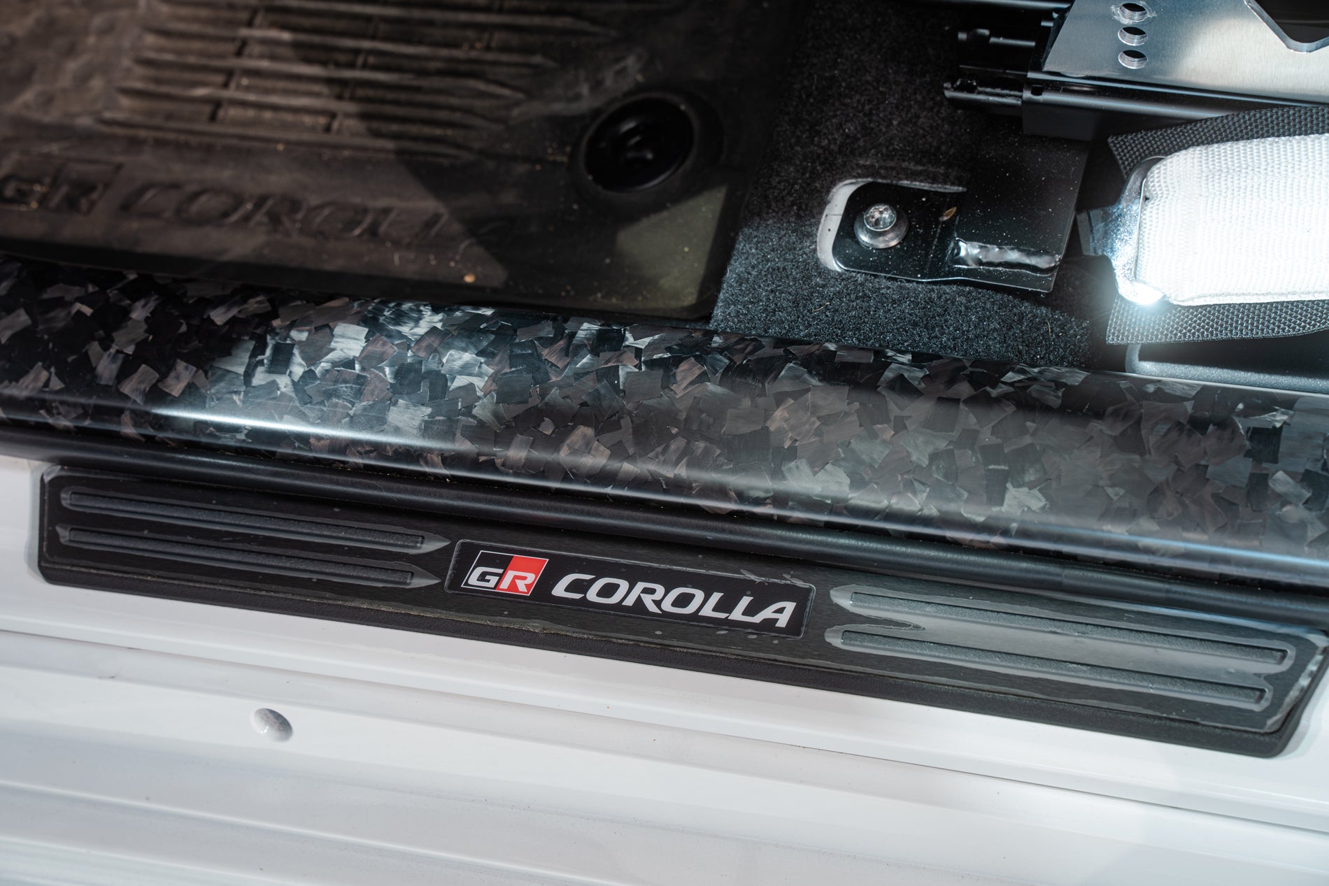 TOM'S Racing - Forged Carbon Front Scuff Plate Cover - Toyota GR Corolla [2023+] / Toyota Corolla Hatchback [2019+]